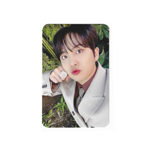 Photo card with a young man in a light jacket, holding a silver ring earring.