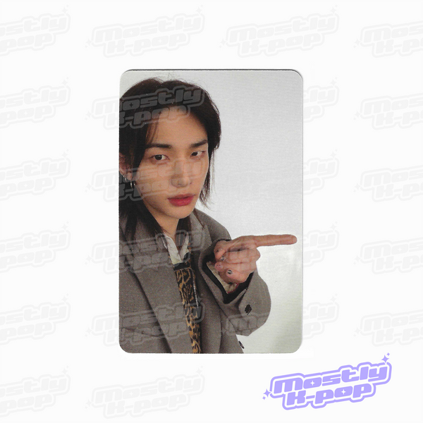 Photo card with a member portrait in a gray blazer and pointing gesture