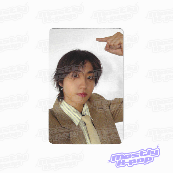 Photo card with a member portrait in a brown jacket and pointing gesture
