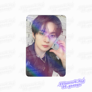 Round-corner photo card of a member with dark hair, one hand by face, iridescent print