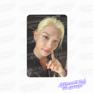 Single portrait photo card of blonde member in black jacket and striped shirt