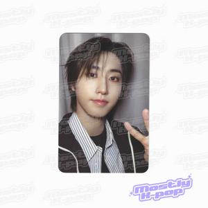 Single portrait photo card of dark-haired member in black jacket and striped shirt