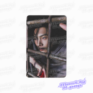 Rectangular photo card showing a close-up portrait with a dark hood and face visible.