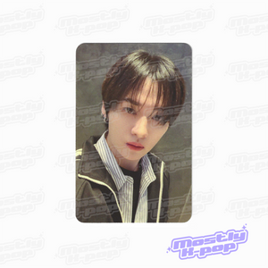 Single portrait photo card of brown-haired member in black jacket and striped shirt