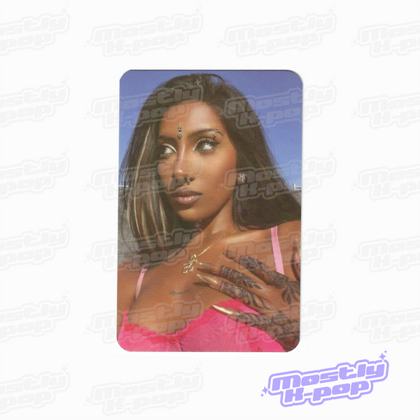 Collectible photocard with a portrait of a woman in a pink top and dark hair