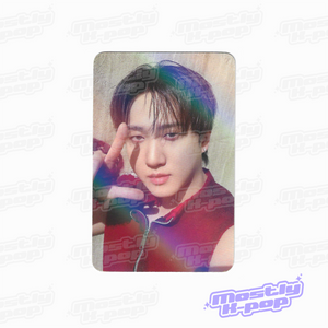 Round-corner photo card of a member with dark hair, finger near temple, iridescent print