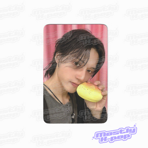 ATEEZ key chain photo card with a member holding a yellow character charm