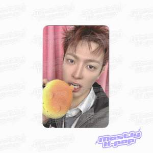 ATEEZ key chain photo card with a member holding a yellow character charm
